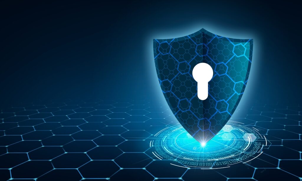 a shield icon with squares, hexagons, and a keyhole; this image is used to signify a need for cybersecurity
