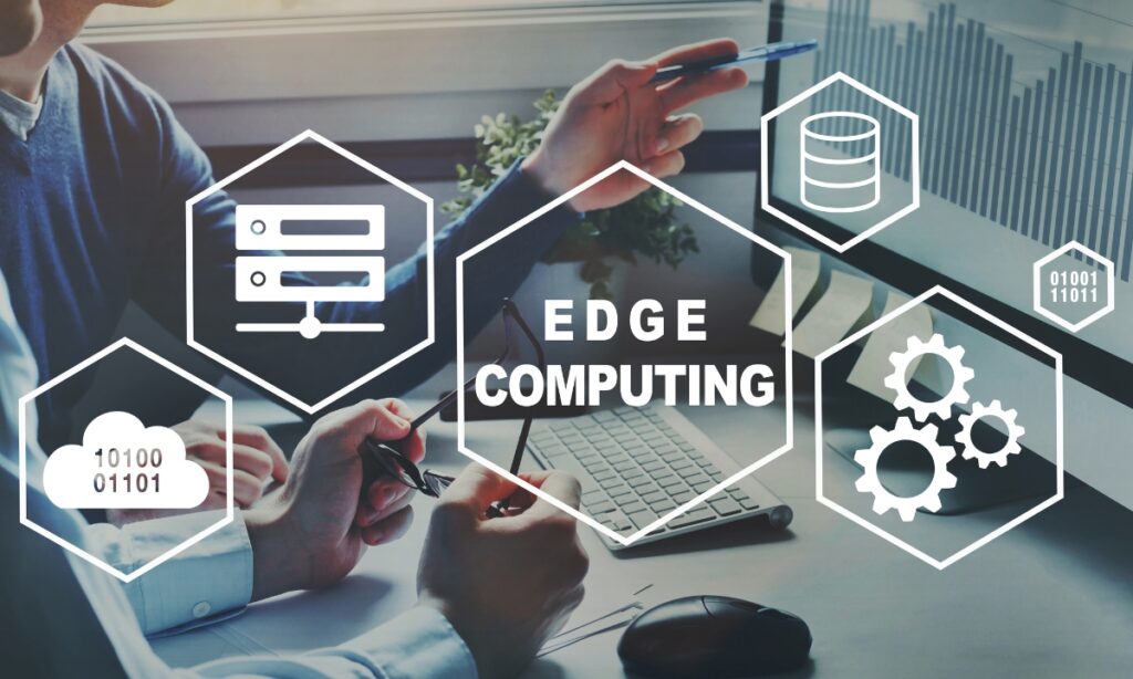 two males pointing at a computer screen with the words "edge computing" floating in front of them