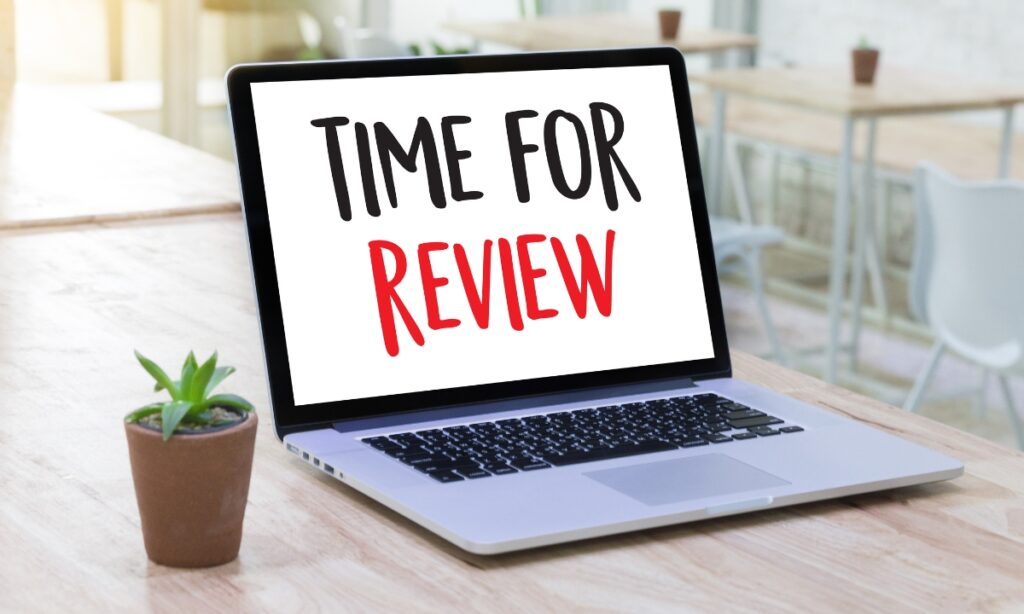 a laptop that says "time for review" on the screen