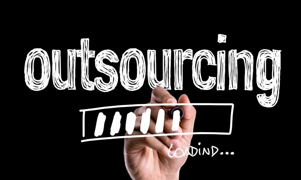 a hand writing "outsourcing" with a small "loading" written in the corner and a loading logo in the middle