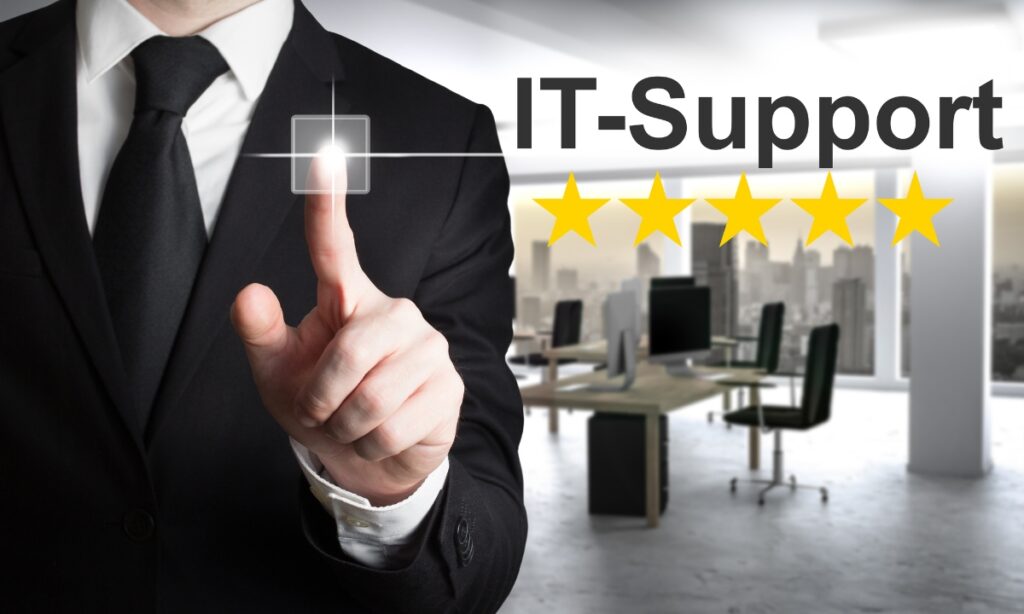 a person's hand pressing a small square next to the words "IT-Support" and five yellow stars