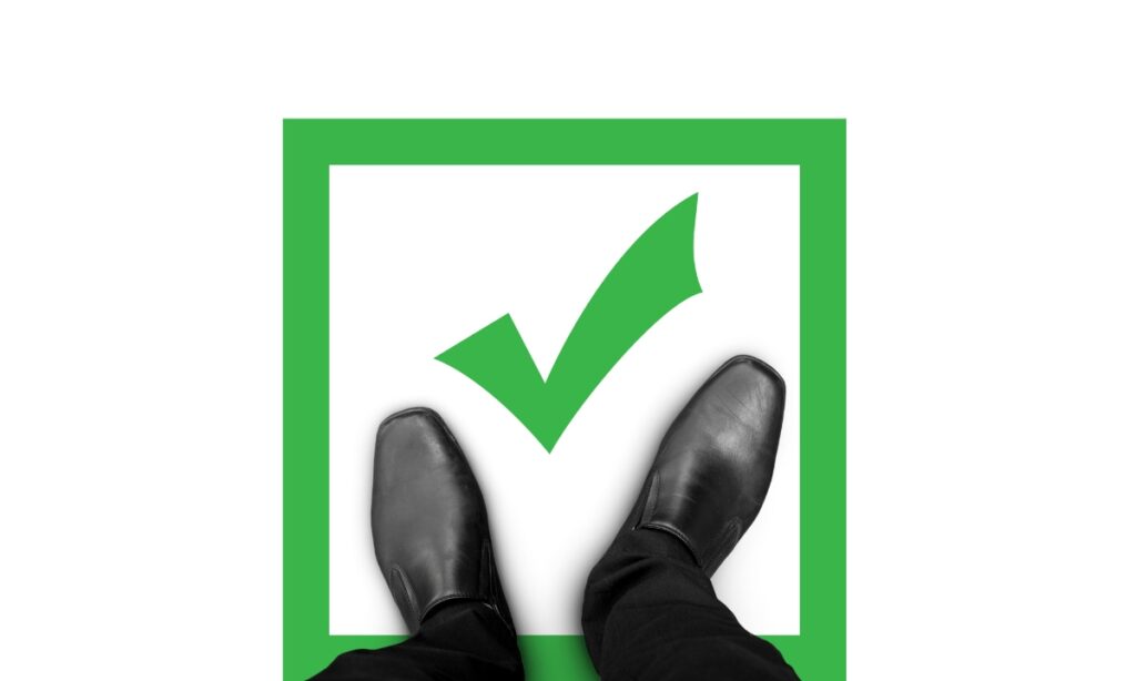 men's shoes standing on a green square with a checkmark in it