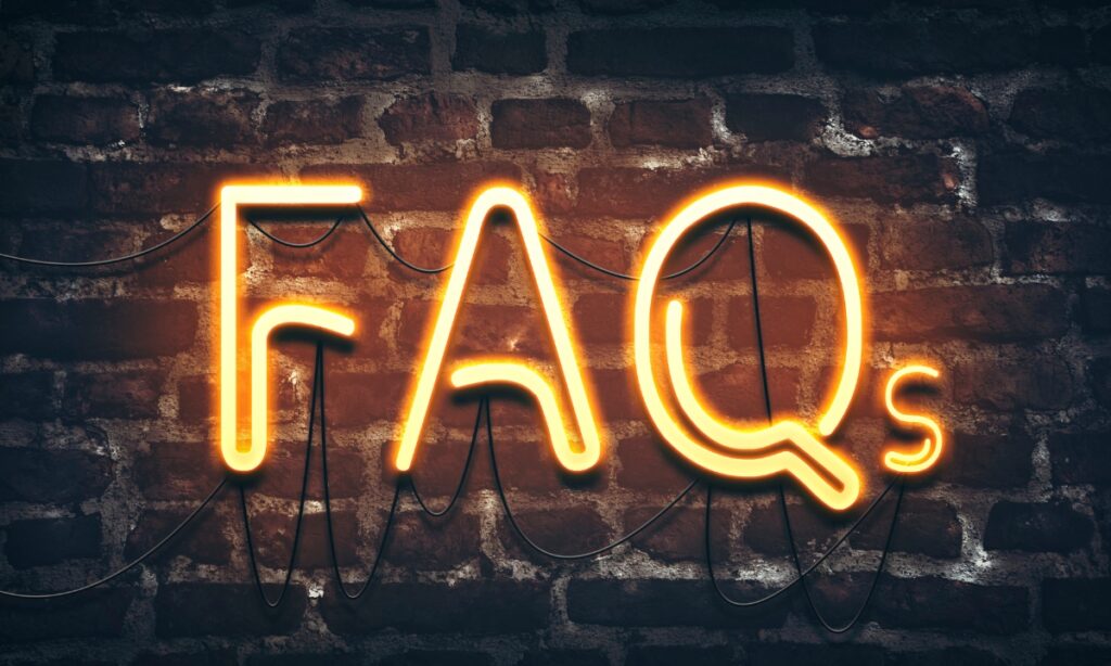 a brick wall with neon lights spelling out "FAQs"