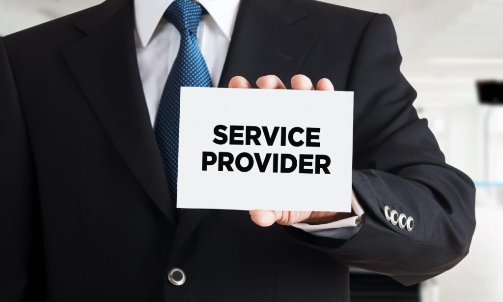 a person in a suit holding up a piece of paper that says "service provider"