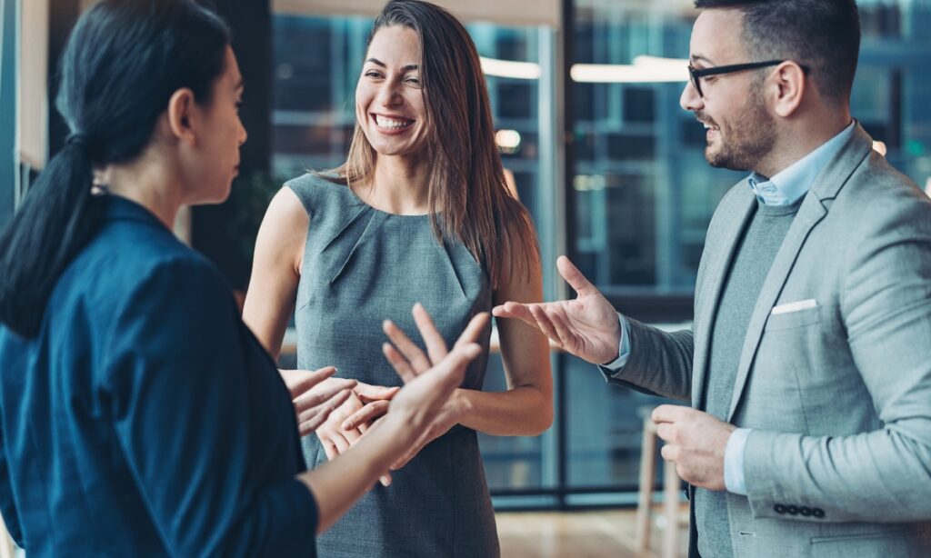 three people in business attire having a conversation