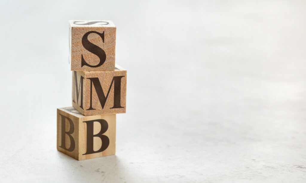 a stack of wooden blocks that say "SMB"