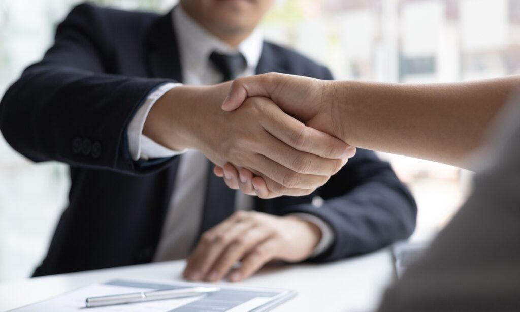 Two business men shaking hands over an agreement